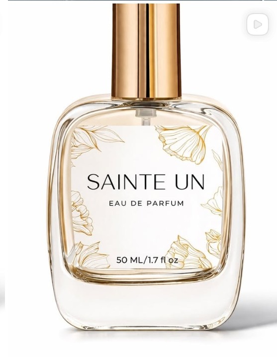 Sainte UN eau de parfum bottle with gold cap and floral label